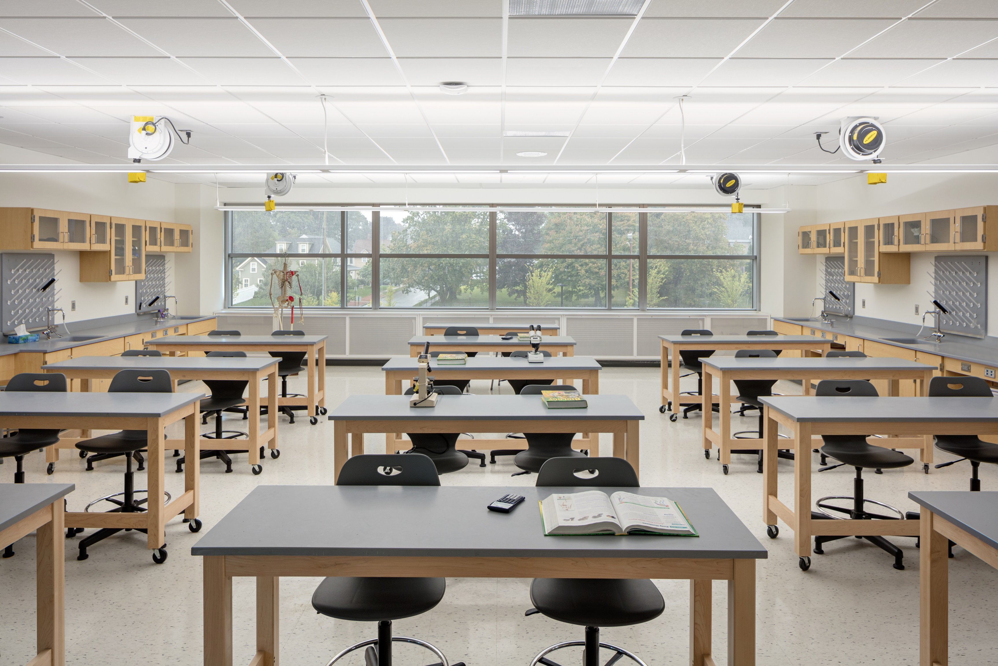 An active chilled beam cabinet installed along the wall of a classroom