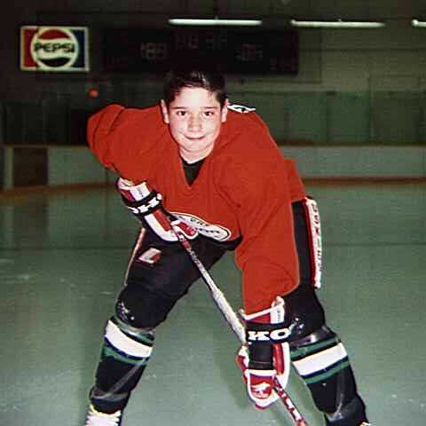 A young Andrew poses for a picture in his hockey gear