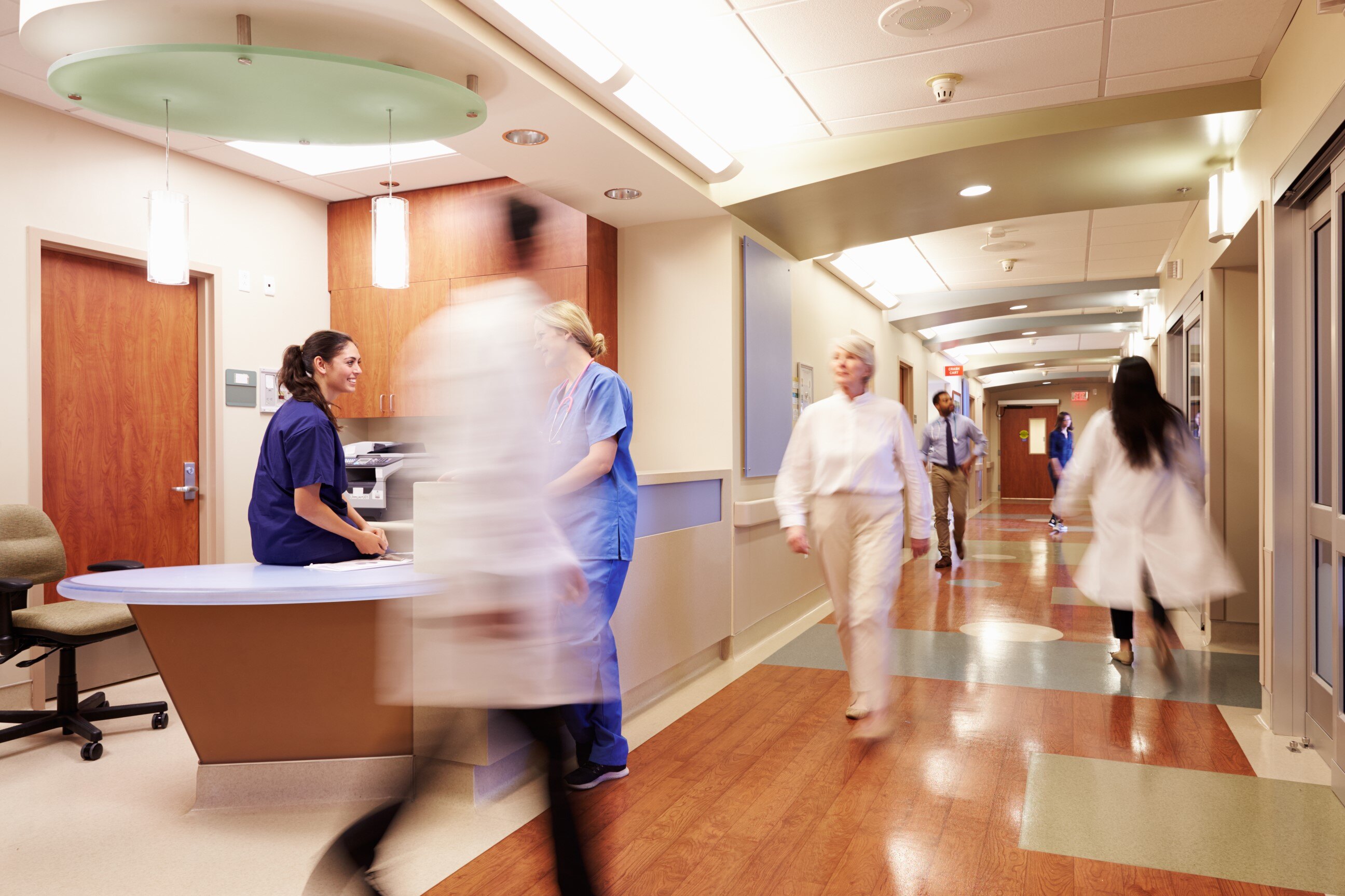 Healthcare staff walking through a hospital corridor