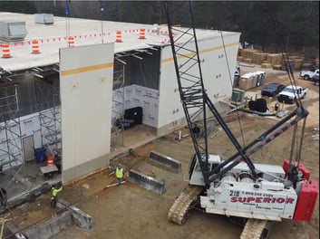 23 tilt-up wall panels being removed with a 110-ton crawler crane