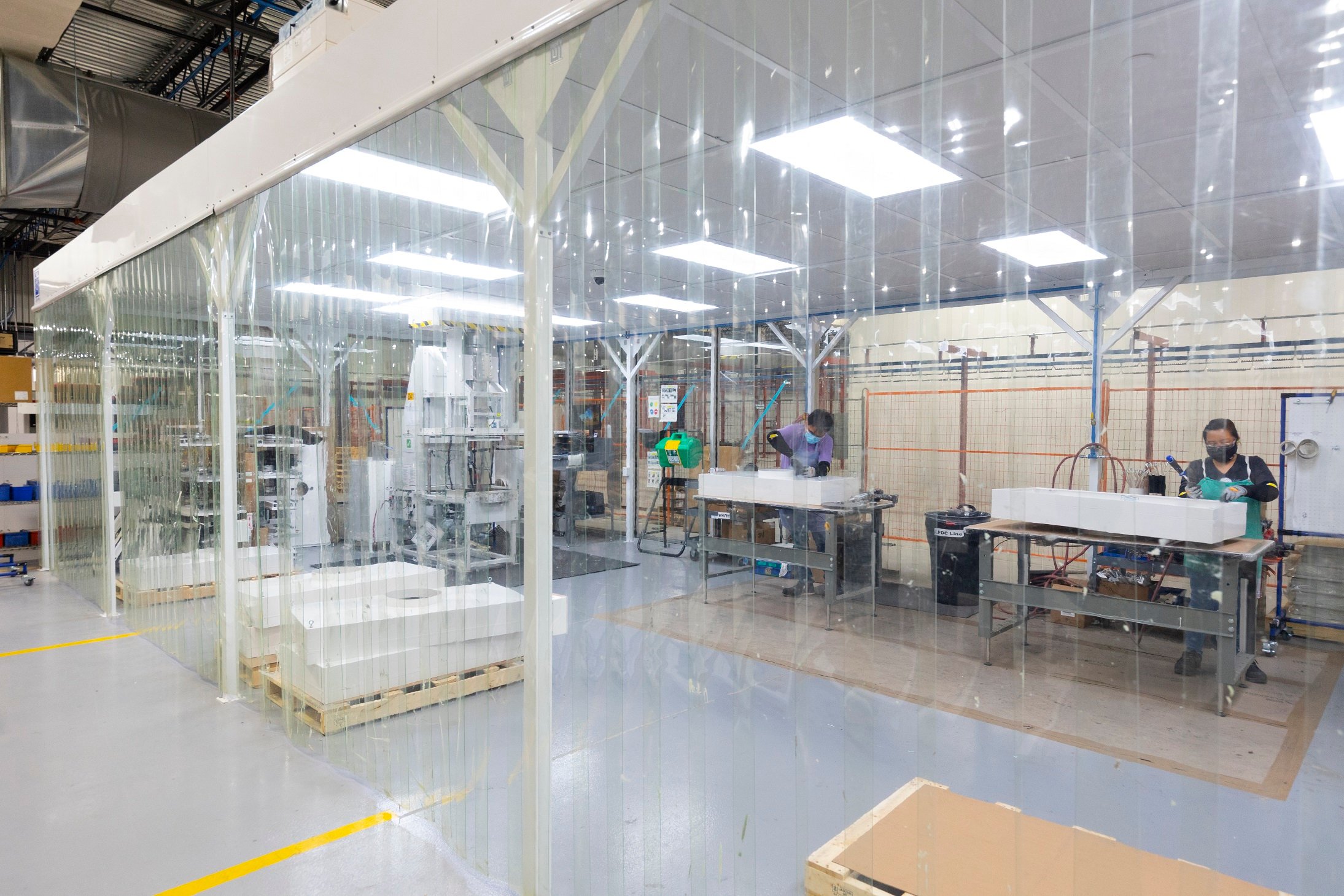 Team members working in a clean manufacturing space