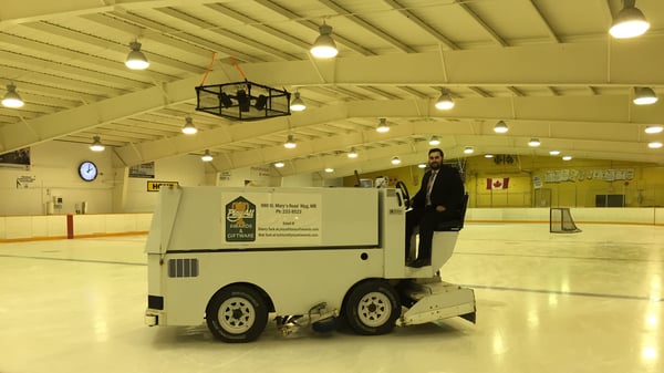 Michael driving a Zamboni at an ice rink