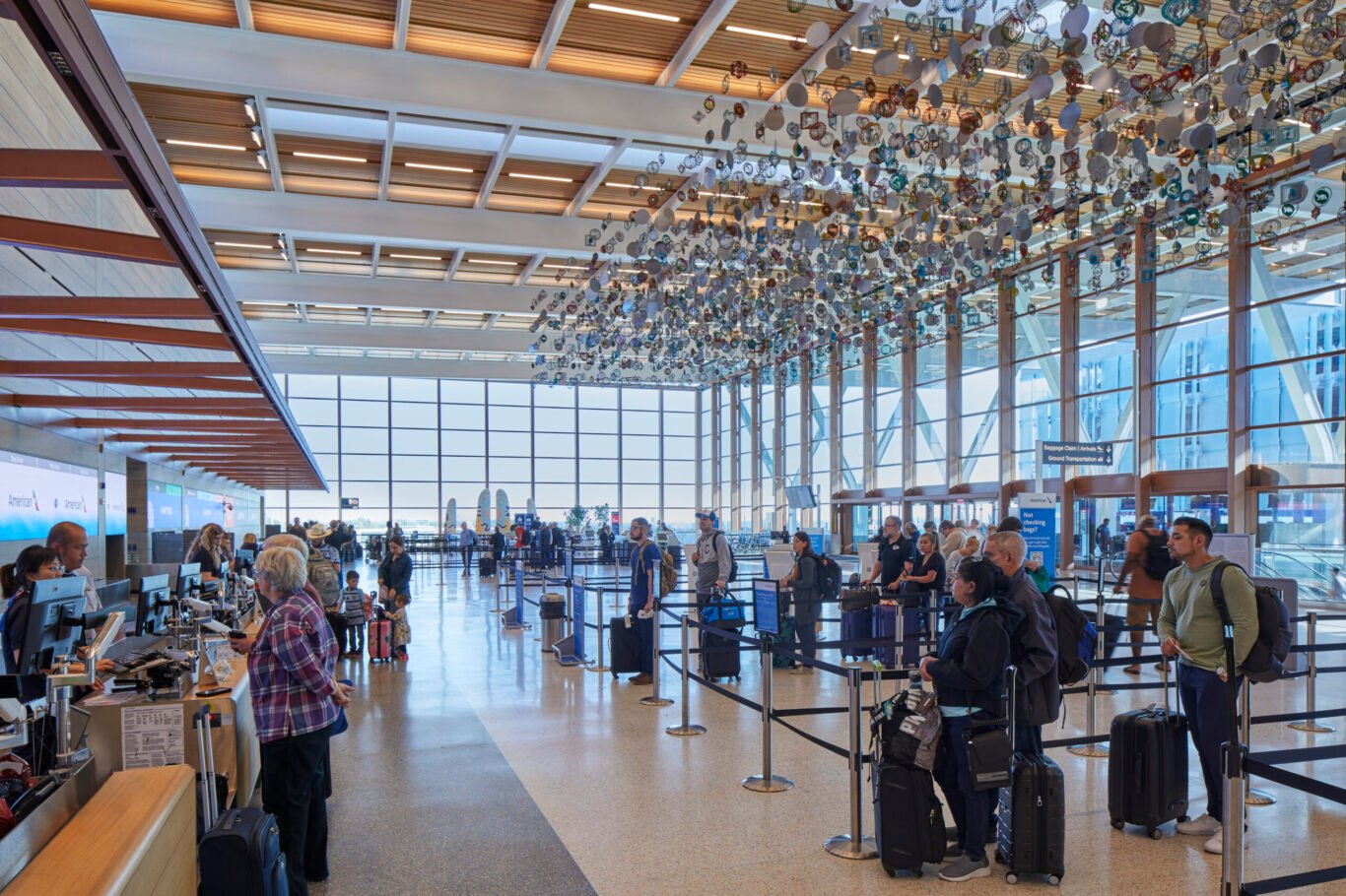 Air travelers gathered in the airport check-in hall