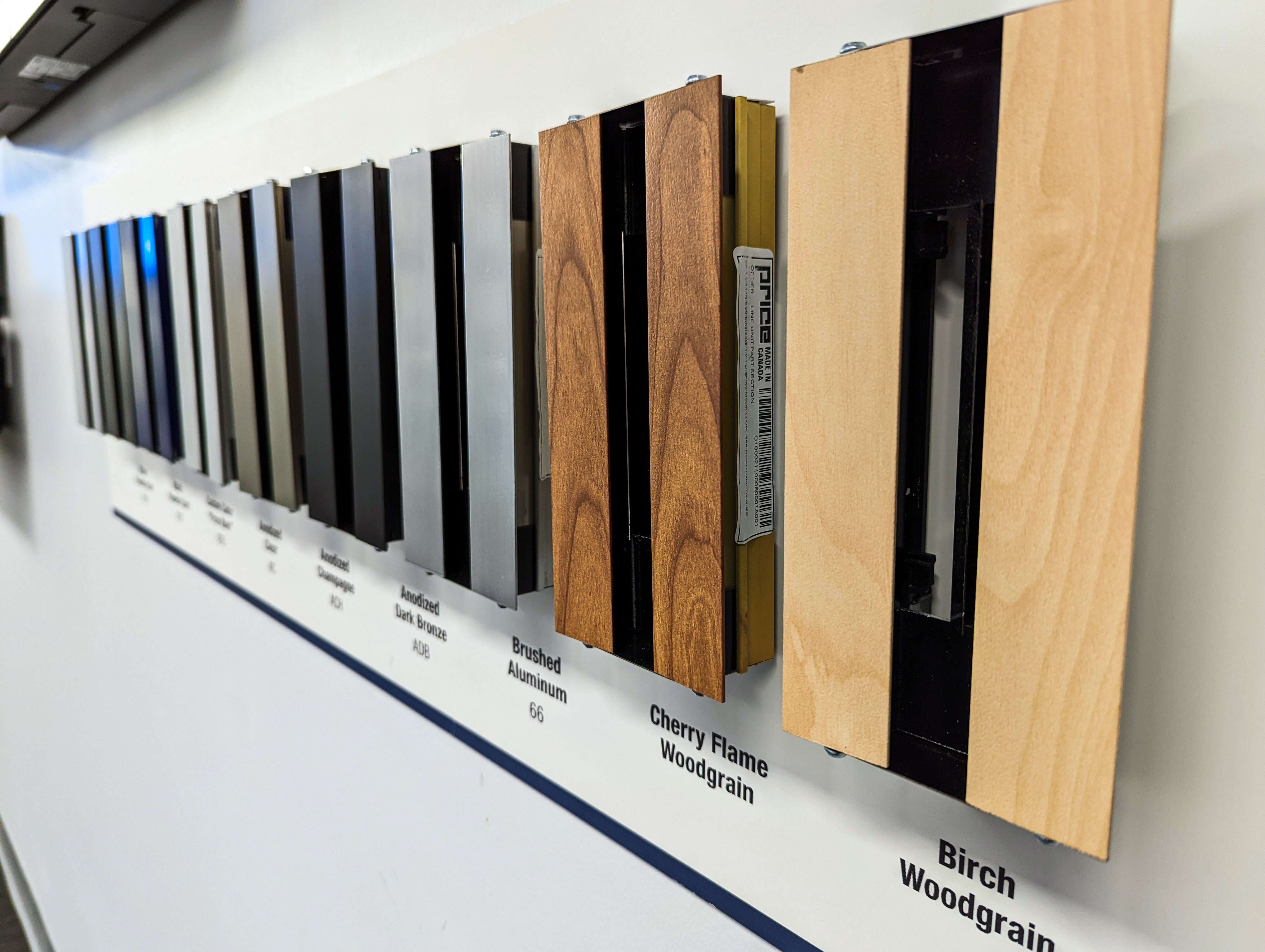 A wall display of several samples of finishes for linear slot diffusers