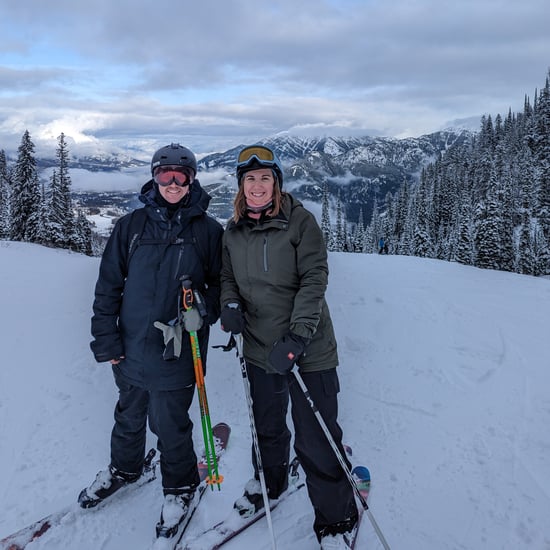 Chris and Ashley in full ski gear on a snowy mountain slope 
