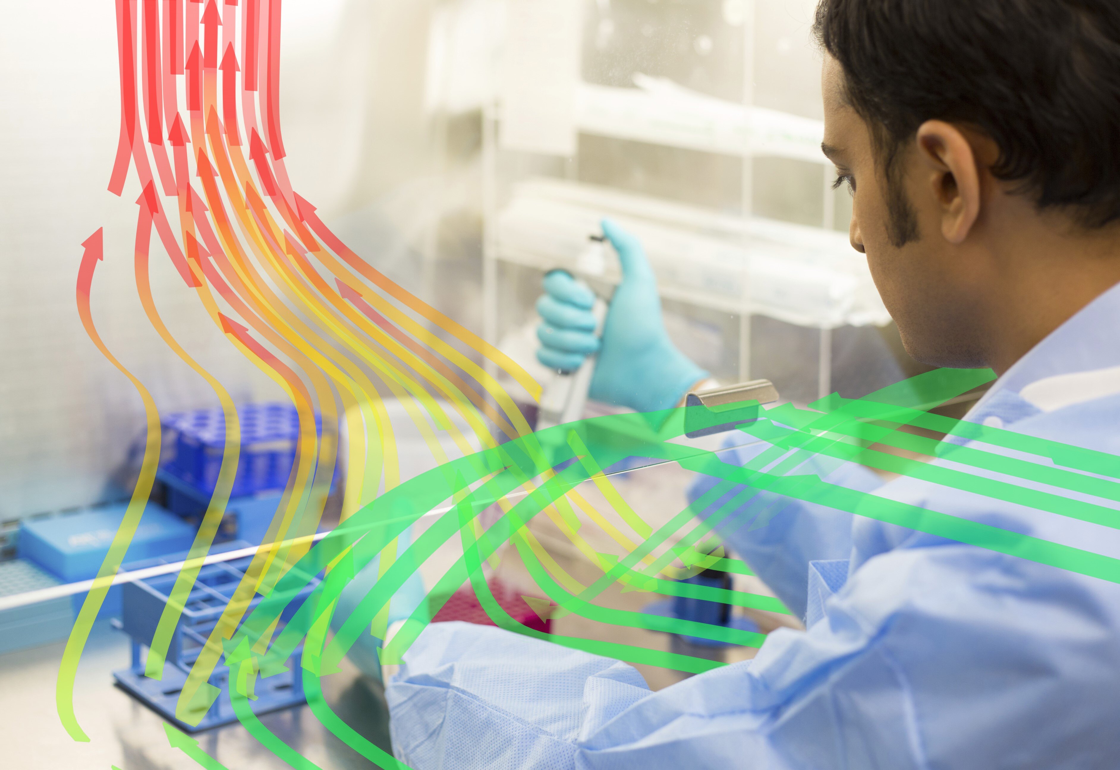 A lab employee working under a fume hood